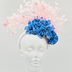 Handmade by Featured Milliner of The Kentucky Derby Museum 2023 & 2024! Blue hydrangeas with generous pink feather bursts and coordinating pink sprouts. Attaches with headband.  Not taking customs this year--Derby 150 is going to be massive and mom life keeps me running! However, happy to suggest pieces that will coordinate with your outfit. If you don't love the way this attaches to your head--message me!  I can swtich *most* pieces to your preference. Clip, Headband OR Elastic Cord  NOTE: Heav Summer Races Ostrich Feather Headpiece, Spring Race Mini Hats With Ostrich Feathers, Spring Formal Headpiece With Feathers, Spring Formal Headpiece With Feather Trim, Formal Spring Headpiece With Feather Trim, Pink Feather Trim Headpiece For Kentucky Derby, Pink Feathered Headpieces For Spring, Ostrich Feather Hats For Spring Races, Pink Mini Hats With Feathers For Spring