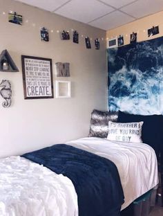 a bedroom with blue and white decor on the walls, bed in front of a large painting