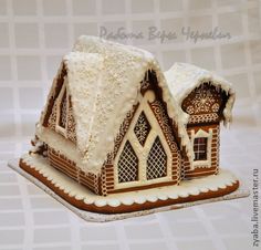 a gingerbread house with icing on the roof