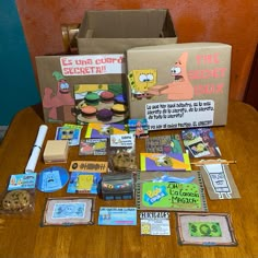 an assortment of items from the simpsons show on a table with a cardboard box in front