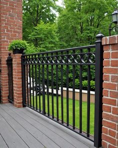 a black iron fence is next to a brick building