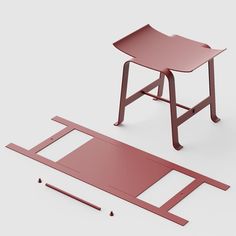 a red desk and chair sitting next to each other on a white surface with holes in the floor