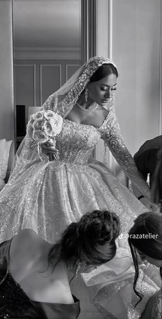 the bride is getting ready to walk down the aisle in her wedding dress and veil