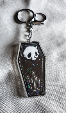 "Creepy cute devil skull coffin shaped coffin shaker charm filled with black holo glitter and four bone charms of little ghosts to haunt your bag or keys. Keychain has both a keyring and lobster claw clasp. Keychain measures 3\" + hangs an additional 3\" with keyring. Check out my other listings for more of Creepy Cute Lowbrow and Gothic fantasy art." Novelty Black Keychain For Gift, Keys Keychain, Shaker Charm, Prince Clothes, Cool Keychains, Goth Accessories, Aesthetic Goth, Skull Keychain, Cute Goth