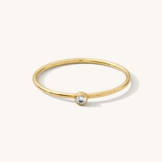 Minimal and sweet, the Tiny Solitaire Ring is ideal for every day. It adds the perfect hint of sparkle and confidence to any occasion. Wear it for your next weekend brunch or girls' night out. It's even comfortable enough to leave on for your favorite yoga class! DETAILS 14k gold filled -or- sterling silver ring 1mm band with 2mm cubic zirconia Available in sizes 5-10 Safe for sensitive skin & shower safe Matching jewelry: Tiny Solitaire Necklace, Solitaire Necklace, Solitaire Ring, Tiny Solita Diamond Birthstone Ring, April Birthstone Ring, B Day Gifts, Dainty Initial Necklace, Multiple Rings, Holiday Wishlist, Diamond Birthstone, Opal Ring Gold, Opal Earrings Stud