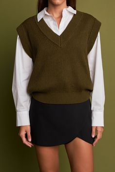 Stay cozy all winter with our must-have solid sweater vest. This versatile and stylish vest is a must-have for the cold weather season. With a relaxed fit, it's perfect for throwing on over any outfit. The soft knit fabric will keep you warm and comfortable all day long. So don't wait, add this essential vest to your wardrobe today! Knit Sleeveless V-neckline Ribbed trim Oversized Fit Hand wash cold Do not bleach Do not tumble dry Iron low Shell: 54% Polyester 20% Nylon 20% Acrylic 6% Wool HN113 Fitted Knit Sweater Vest For Layering, Classic Brown Wool Sweater Vest, Fitted Sleeveless Wool Sweater Vest, V-neck Stretch Sweater Vest For Layering, Essential Vest, Stretch V-neck Sweater Vest For Layering, Oversized Sweater Vest, Summer Style Guide, Solid Sweaters