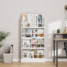 a room with a desk, chair and bookshelf in front of a white wall