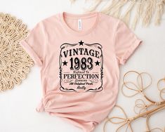 a pink t - shirt that says vintage 1989 perfectionion with stars on the front