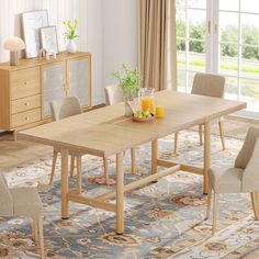 a dining room table with chairs and a vase filled with orange juice on top of it