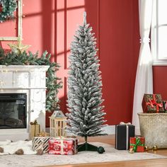 a christmas tree sitting in front of a fire place with presents on the floor next to it