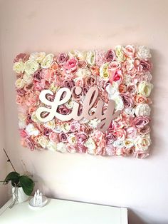 a flower wall with the word monogrammed on it