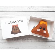 a small stuffed animal in a box with the words i lava you written on it