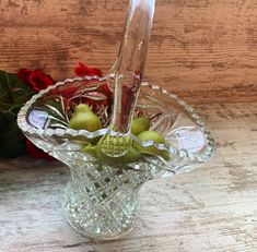 a glass vase filled with flowers on top of a wooden table