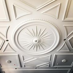 the ceiling is painted white and has geometric designs