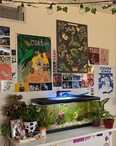 there is a fish tank in the corner of this room with posters on the wall