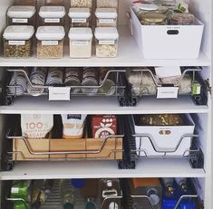 the pantry shelves are organized with containers and bins for food, cereal or other items