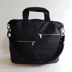 *** Please check 'shop announcement' for production time and delivery before your purchase. ***This sturdy bag is made from black water resistant nylon with black nylon lining. It's very roomy and suitable to be used as your all purpose bag, diaper bag, school bag, messenger bag, everyday tote, travel bag and messenger bag. You can just use the wet cloth to wipe the dirt out once it's get dirty.If you would rather have the bag in different colors (exterior and interior), please select your choic Black Tote Laptop Bag For School, Black Tote Travel Bag For School, Black Crossbody Laptop Bag For School, Black Functional Diaper Bag With Removable Pouch, Large Capacity Black Diaper Bag For On-the-go, Functional Black Diaper Bag For Daily Use, Black Travel Bag With Zipper Pocket For School, Functional Black Backpack Diaper Bag, Black Large Capacity Diaper Backpack