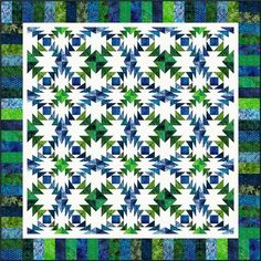 a blue and green quilt with stars on it