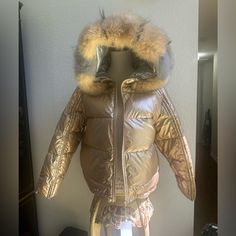 Reversible Silver Or Gold Fur Trimmed Hood Fitted Gold Winter Outerwear, Gold Hooded Winter Outerwear, Metallic Hooded Winter Outerwear, Luxury Puffer Jacket With Faux Fur Lining, Metallic Long Sleeve Winter Outerwear, Luxury Metallic Outerwear For Fall, Silver Hooded Outerwear For Winter, Luxury Silver Outerwear For Winter, Herno Woman