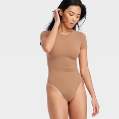 This 4-Way Stretch Short-Sleeve Bodysuit from Auden™ in a solid color features a simple crewneck for pullover style and cotton gusset for breathability. Made from lightweight four-way stretch fabric it offers a comfortable fit that moves with you, and the opaque lining offers confident wear. You can wear this bodysuit with everything from wide-leg trousers to joggers to shorts, and add layering pieces for versatile styling options. Auden™: Comfort true to every shape & hue. Summer Crew Neck Short Sleeve Bodysuit, Everyday Solid Fitted Bodysuit, Basic Short Sleeve Stretch Bodysuit With Crew Neck, Basic Stretch Short Sleeve Bodysuit With Crew Neck, Fitted Solid Color Bodysuit With Crew Neck, Casual Bodysuit With Minimal Stretch, Basic Crew Neck Bodysuit For Summer, Basic Short Sleeve Crew Neck Bodysuit, Fitted Solid Color Crew Neck Bodysuit