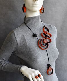 "Bohemian spiral black necklace with orange accent, Statement bold necklace, Contemporary necklace, Unusual necklace. Bib necklace or set... Beautiful playful spiral necklace. Long, elegant, rich in shapes. Black necklace with orange accent. Gorgeous stylish bohemian necklace. Eye catching artistic jewelry. Necklace is soft and light, very comfortable to wear. Dimensions: - Necklace length: 23\" / 59cm (around neck). - Earrings length: 2\"/ 5cm; Total drop length: 2.8\"/ 7cm. - Ring size by orde Handmade Orange Necklaces For Party, Unique Orange Necklace For Party, Spiral Black Necklace As A Gift, Black Spiral Necklace For Gift, Black Spiral Necklace As A Gift, Unique Orange Long Necklace, Unique Long Orange Necklace, Unique Black Spiral Jewelry, Adjustable Black Spiral Necklace