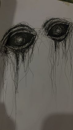 a drawing of two eyes with long hair on it's face and one eye is drawn