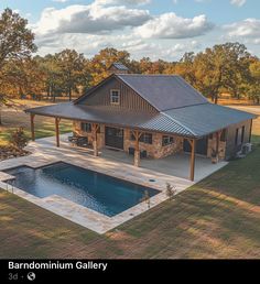 an aerial view of a house with a pool in the foreground and covered patio