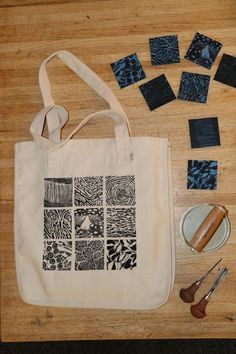 a tote bag, scissors, and other crafting supplies on a wooden table