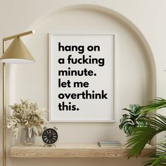 a poster with the words hang on a wall above a shelf