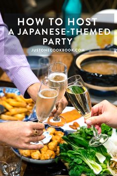 two people toasting with champagne glasses in front of food on the table and text overlay reads how to host a japanese themed party