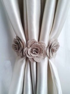 the curtain is decorated with flowers and burlocked in silver satine fabric