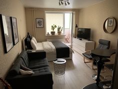 a living room filled with furniture and a flat screen tv