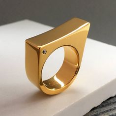 Sign up now and get 10% off your first purchase https://signup.majdanrocks.com This minimalist and sophisticated cocktail ring is a divine day to night ring. It would make a great gift for your wife, girlfriend, mother, sister, daughter or friend.  It comes in both Matt and Mirror finish (please indicate which you would prefer when placing your order).   All my jewellery is handmade in London, UK.  Made from sterling silver and available in 18ct gold plate, and 18ct rose gold plate. It includes 2 1.5mm SI quality diamonds, one on each side. Width of ring: 8 mm Weight: 14 g Same design also available without diamonds: https://www.etsy.com/uk/listing/208361885/minimalist-gold-ring-statement-ring?ref=shop_home_active_2 If you would like to order the ring in 9ct, 14ct, or 18ct gold, please dro Modern Diamond Rings With Polished Finish, Modern White Gold Dome Ring For Anniversary, Modern Diamond Signet Ring As Gift, Modern Signet Ring With Single Diamond In Open Style, Modern Diamond Signet Ring With Open Design, Modern Open Signet Ring With Single Diamond, Modern Gold Signet Ring With Tension Setting, Minimalist Signet Ring With Single Cut Diamonds, Minimalist Formal Signet Ring With Single Diamond