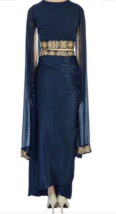 Saree is pre-stitched Saree is pre-pleated Saree is pre-made Stunning navy blue saree that has a pleated maxi skirt with floral motif work paired with cape-style cropped blouse. This set comes with sequin embellished drape! The fabric is modal satin and georgette. Diwali Evening Art Silk Pre-draped Saree, Party Floor-length Art Silk Pre-draped Saree, Silk Sharara For Evening And Diwali, Silk Sharara For Diwali Evening, Unstitched Evening Sharara For Party Wear, Evening Festive Saree Set, Silk Pre-draped Saree For Navratri Party, Evening Pre-draped Saree With Unstitched Blouse For Navratri, Festive Pre-draped Maxi Length Georgette Saree