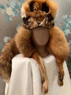 "This, incredibly, wonderful, winter hat has everything going for it. The design points are multiple and such fun! Skin Head hats are known for their attention to details and this red fox, hat does not disappoint. Trapper style at its best; fox face, ear flaps with paws attached, full tail and fold down flaps all around. Suede crown with leather stitching. The inside of the done has a sheered fur lining. This hat looks like it has not been worn. 27 1/2\", 6\" dome" Jackie Brown, Fox Hat, Fox Face, Leather Stitching, Trapper Hats, Red Fox, Tan Suede, Winter Hat, Fox Fur