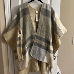 Bought From Francescas Color Is Beige, Gray, White One Size Fits All Super Comfy Material Ties In Front Definitely Have To Wear Something Underneath Because Sides Are Open Fast Shipping And From A Smoke Free Home! Oversized White Poncho For Fall, Casual Cream Poncho For Fall, Oversized White Cape Outerwear, Oversized Long Sleeve Cream Poncho, Casual Oversized Cream Poncho, Cream Oversized Long Sleeve Poncho, White Oversized Winter Cape, Oversized Long Sleeve Beige Cape, Casual Beige Long Sleeve Cape