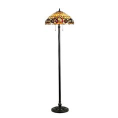 a floor lamp with a stained glass shade on the top and an iron pole base