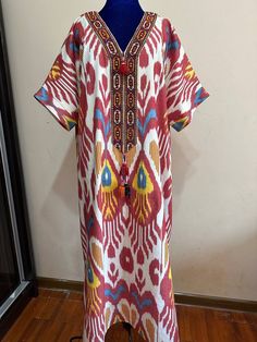 This dress is made of cotton ikat fabric.In Uzbek tradition, women sewed dressed from  these fabrics and wore this type  of dresses to weddings.By this time,girls and women are wearing dresses from vintage loving. Care;dry cleaning only. Length;125cm  / 49inches. Sleeve:37cm  /14,5inches. Chest:134cm/53inches. Size:Oversize. Every item will be shipped from Uzbekistan via postal service. Tracking number will be provided. PROCESSING TIME; 1-2 WORK DAYS. SHIPPING TIME; 2-4 WEEKS. SHIPPING COST; $25 for 1set. $15 for each additional item. Bohemian Cotton Handloom Dress, Bohemian Maxi Dress For Traditional Ceremonies, Traditional Cotton Maxi Dress With Multicolor Embroidery, Traditional Multicolor Embroidered Cotton Maxi Dress, Folk Style Cotton Kaftan With Woven Motifs, Traditional Patterned Dresses For Festival, Traditional Multicolor Cotton Maxi Dress, Traditional Patterned Festival Dresses, Bohemian Kaftan With Multicolor Embroidery And Woven Motifs