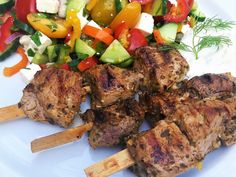 several skewers of meat and vegetables on a plate