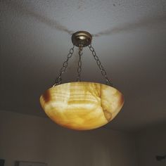 a light fixture hanging from the ceiling in a room