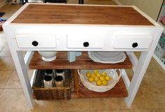 a kitchen island with two drawers on each side and some lemons in the bottom drawer