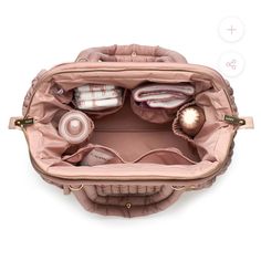 the inside of a pink purse with its contents in it