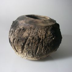 a stone vase sitting on top of a white table