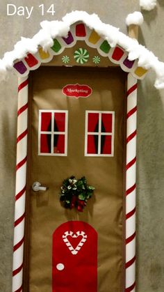 a door decorated to look like a gingerbread house with candy canes on it