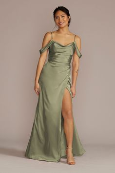 a woman in a long green dress with one leg slited up and the other side split