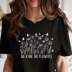 PLEASE NOTE, DUE TO THE BUSY HOLIDAY SEASON ANY ORDERS PLACED AFTER 12/09/24 ARE NOT GUARANTEED TO ARRIVE BY CHRISTMAS.This inspirational quote Wildflower No Rain No Flowers Graphic tee would make the perfect gift for the nature lover in your life.  Comes in multiple colors! ❤️ Our Unisex T-shirts are High Quality, SUPER soft and SUPER comfy. They are made of 100% Cotton. Heather tees are a soft cotton-poly blend. This listing is for our BELLA+CANVAS T-shirts! We also carry Gildan and Comfort Co Inspirational Letter Print T-shirt For Spring, Inspirational Graphic Print T-shirt As Gift, Inspirational Slogan T-shirt For Spring, Plants Print Crew Neck T-shirt Gift, Plants Print Crew Neck T-shirt For Gift, Crew Neck T-shirt With Plants Print, Inspirational Letter Print Top As Gift, Inspirational T-shirt With Letter Print As Gift, Inspirational Letter Print T-shirt As Gift