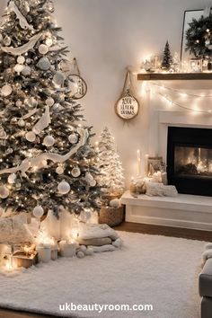 a living room decorated for christmas with white and silver decorations on the tree, fireplace mantel and mantle