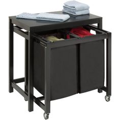 a black table with two bins and towels on top