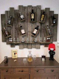 a wooden shelf with wine glasses and bottles on it