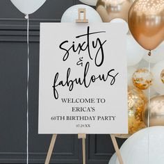 a sign that says sixty and fabulous is in front of some gold and white balloons